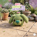 A crocheted plush cactus puppy toy sits on a stone patio in a garden setting, with potted succulents and decorative rocks in the background. A colorful text overlay reads 'MEET.