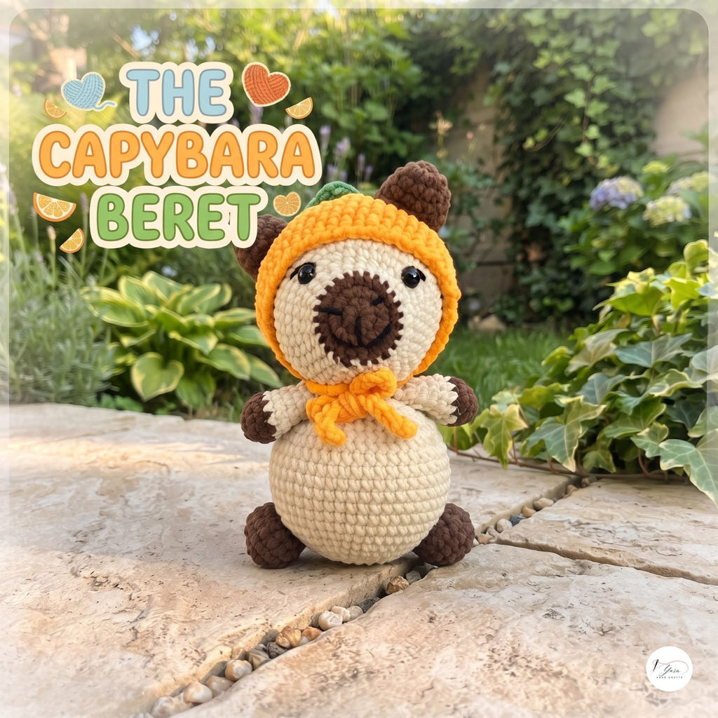 A crocheted capybara plush toy wearing an orange hat and matching orange scarf, sitting outdoors on a stone path with garden plants in the background. The text 'THE CAPYBARA BERET' appears in the upper left.