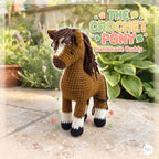 A crocheted pony doll standing on a stone patio with garden plants in the background. The text overlay reads 'THE CROCHET PONY Handmade Buddy' and there is a small logo in the bottom right corner.