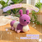 A handmade crochet caterpillar plush toy in purple and cream, sitting on a wooden floor with a cozy background of plants and a blanket. Text overlays read 'CUTE CROCHET CATERPILLAR' and 'HANDMADE PLUSH & CUDDLY'.