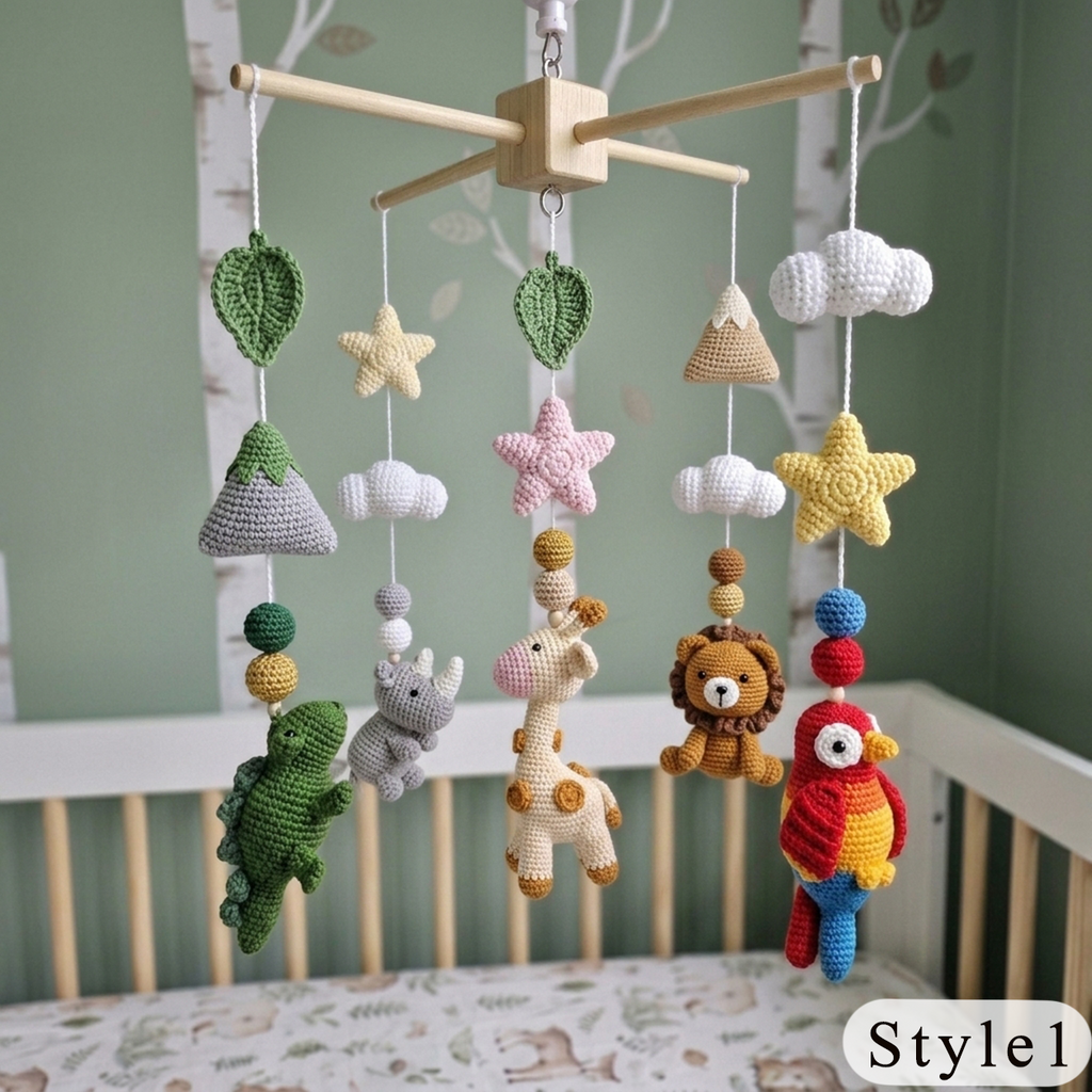A crocheted baby mobile with safari-themed plush toys including a green dinosaur, pink giraffe, brown lion, red parrot, yellow star, and white cloud charms hanging from a wooden crossbar in a crib.