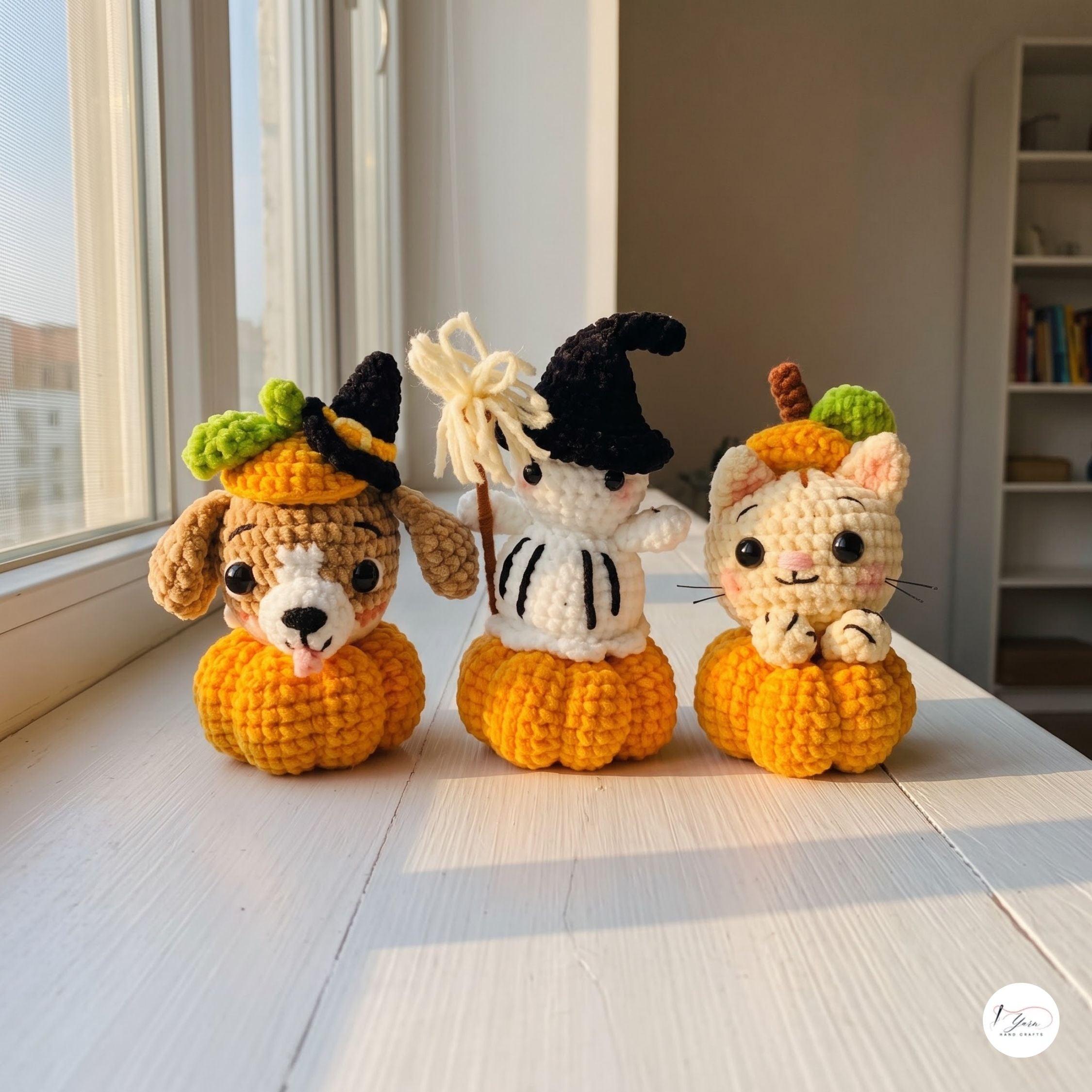 Three crocheted amigurumi Halloween characters sitting on small orange pumpkins on a sunlit white windowsill. The left figure is a dog with floppy ears, a black witch hat, and a green leafy top.