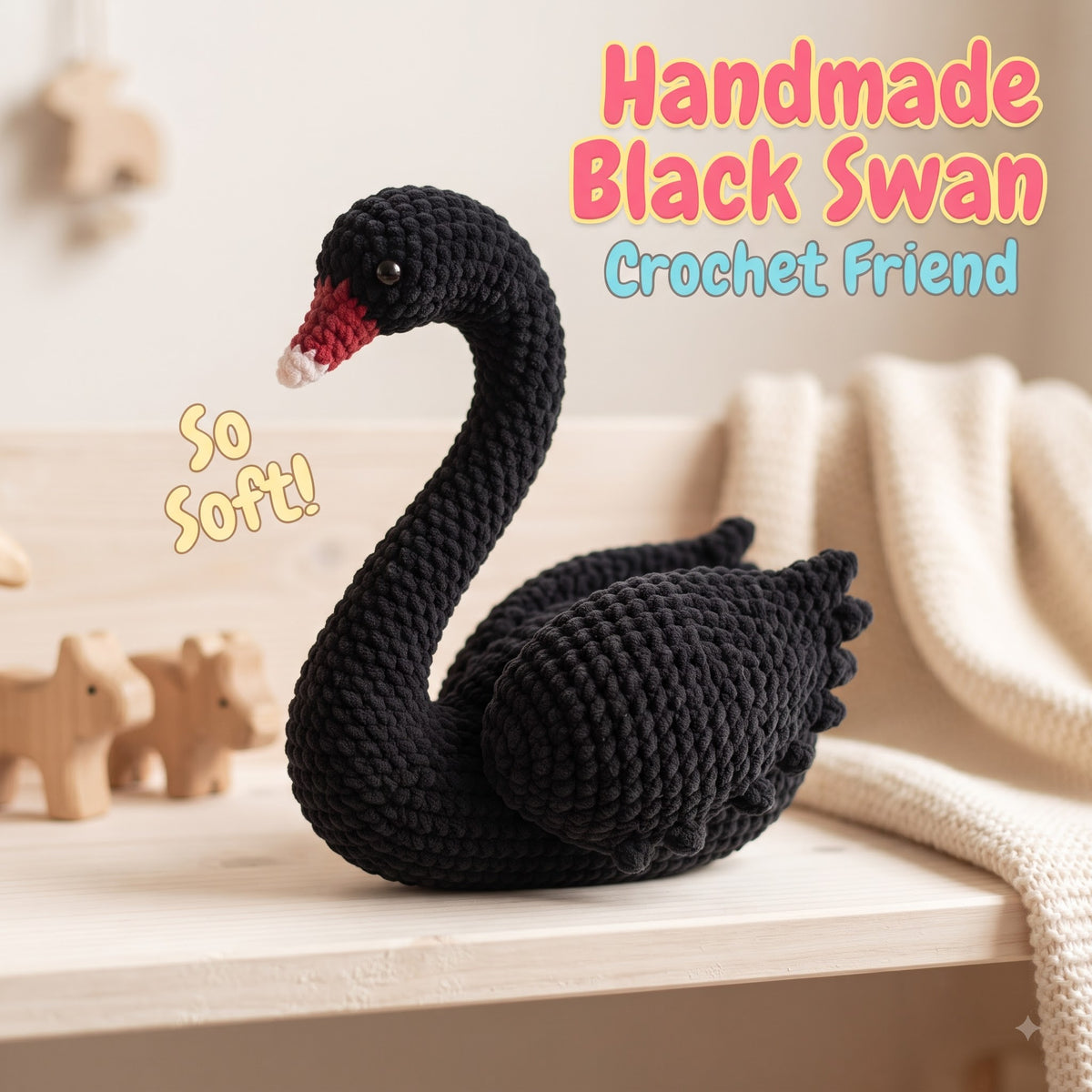 A handmade black crocheted swan toy with a red and white beak, sitting on a light wooden shelf next to a cream knitted blanket. The text 'Handmade Black Swan Crochet Friend' and 'So Soft!' are overlaid on the image.