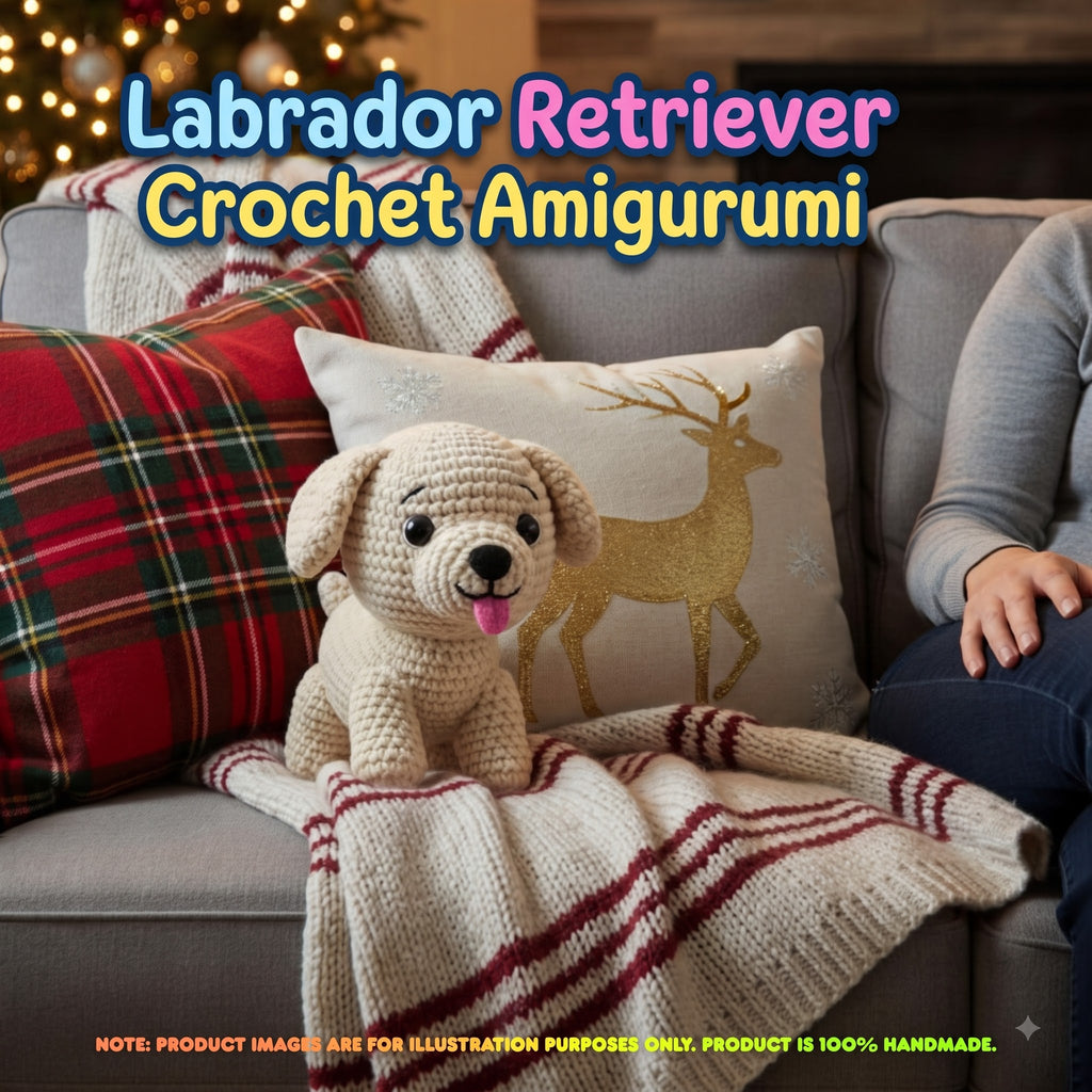 A crocheted Labrador Retriever plush toy sits on a gray sofa wrapped in a cream knit blanket with red stripes, alongside a red plaid pillow and a decorative pillow with a gold deer design. Large text at the top reads 'Labrador Retriever Crochet Amigurumi' and a note at the bottom says the product is 100% handmade.