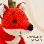 Close-up of a crocheted fox toy with bright red, white, brown, and green details, shown against a soft cream background with the text 'ADORABLE DETAILS' in the lower right.