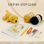 Crocheted puppy kit with a yellow crochet puppy toy, two balls of yarn (one tan, one black), a crochet hook, scissors, glue, ring binder, and a printed step-by-step guide on a beige fabric background with 'STEP-BY-STEP GUIDE' text at the top.