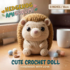 A crocheted hedgehog doll sits on a wooden table in a warm indoor setting, with yarn balls, a mug, and a window in the background. Text overlays read 'HEDGEHOG AMIGURUMI', '6 INCHES / 16cm', and 'CUTE CROCHET DOLL HANDMADE WITH LOVE'.