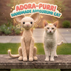A beige crocheted amigurumi cat sits beside a real cat outdoors on a stone ledge, with decorative text reading 'ADORA-PURR! HANDMADE AMIGURUMI CAT' and sparkles around the scene.