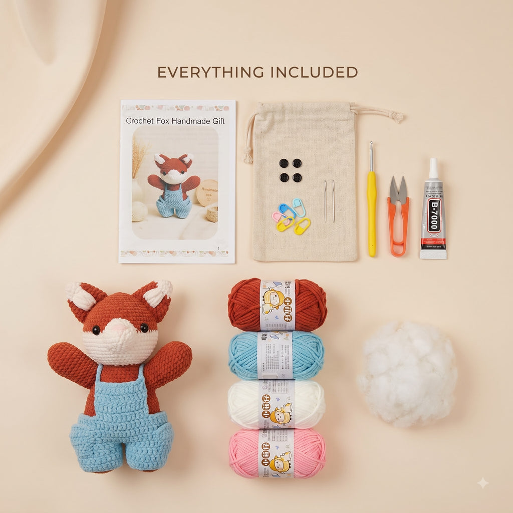 A flat-lay product presentation of a crochet kit titled 'EVERYTHING INCLUDED' on a warm beige background. The kit contains a finished crocheted fox toy in orange and blue, four balls of yarn in red, light blue, white, and pink, a ball of white stuffing, a beige drawstring pouch, a crochet hook, scissors, and a glue tube, alongside a printed instruction card.