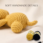 A close-up of a handmade crocheted plush toy in a warm mustard yellow color, with two balls of yarn (one yellow, one black) and the text 'SOFT HANDMADE DETAILS' at the top.