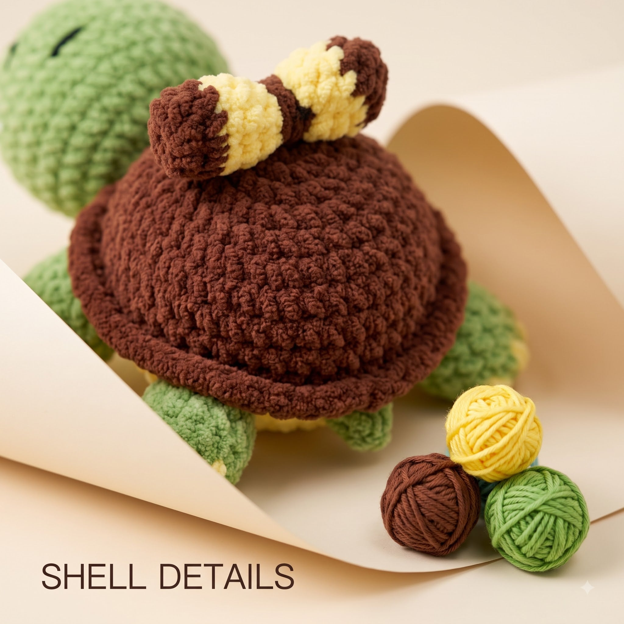 Close-up of a crocheted turtle toy with a brown shell, green body, and yellow-and-brown striped tail, styled on beige paper with small yarn balls and the text 'SHELL DETAILS'.