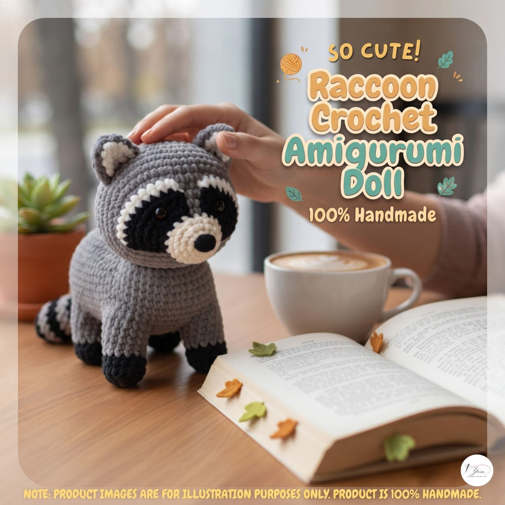 A crocheted raccoon amigurumi doll sits on a wooden table next to an open book, a coffee cup, and a person's hand gently touching its head. Text on the image reads 'So Cute! Raccoon Crochet Amigurumi Doll 100% Handmade'.