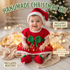 A baby wearing a handmade Christmas outfit set consisting of a red dress with a green bow, matching red booties, and a Santa hat, sitting on a blanket with warm fairy lights. Text overlays describe the set and its contents.