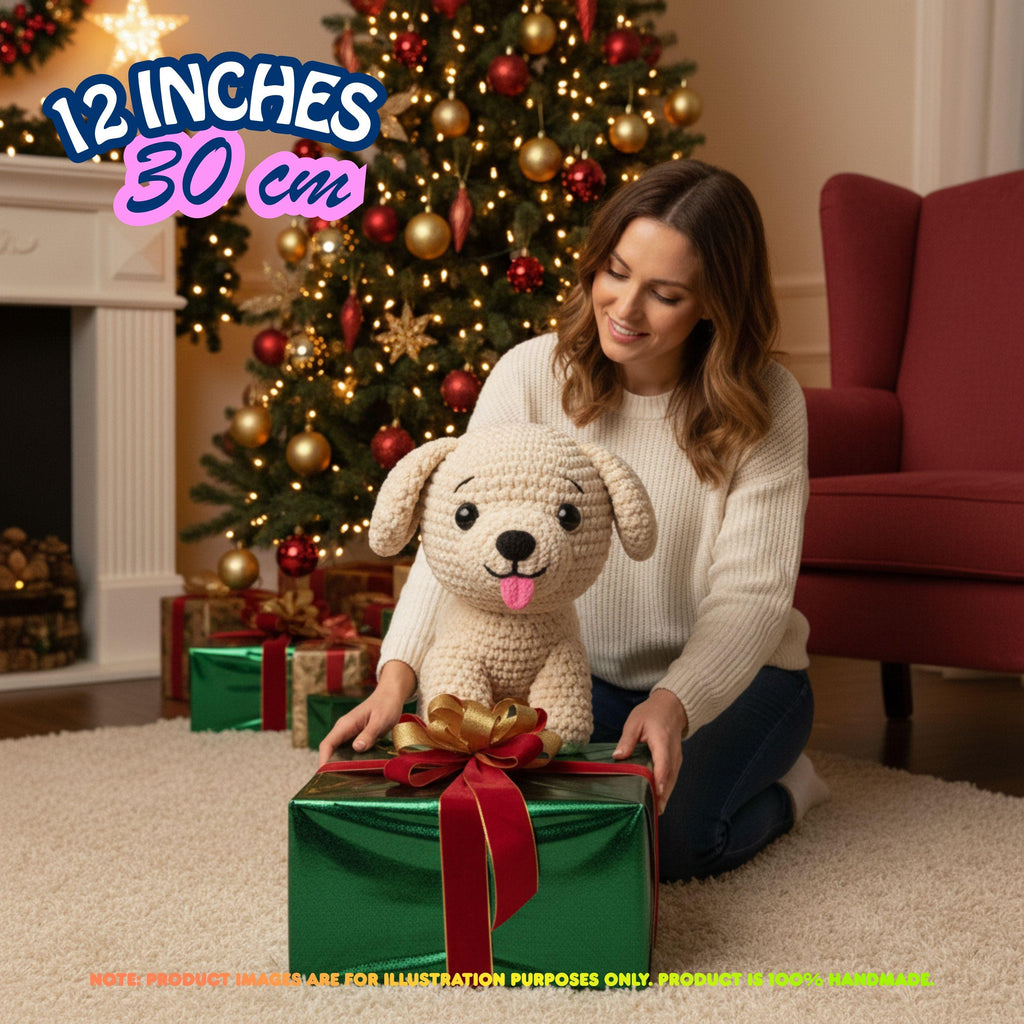 A woman kneels on a carpet in front of a decorated Christmas tree, holding a crocheted plush puppy toy. A green gift box with a red ribbon sits in front of her.
