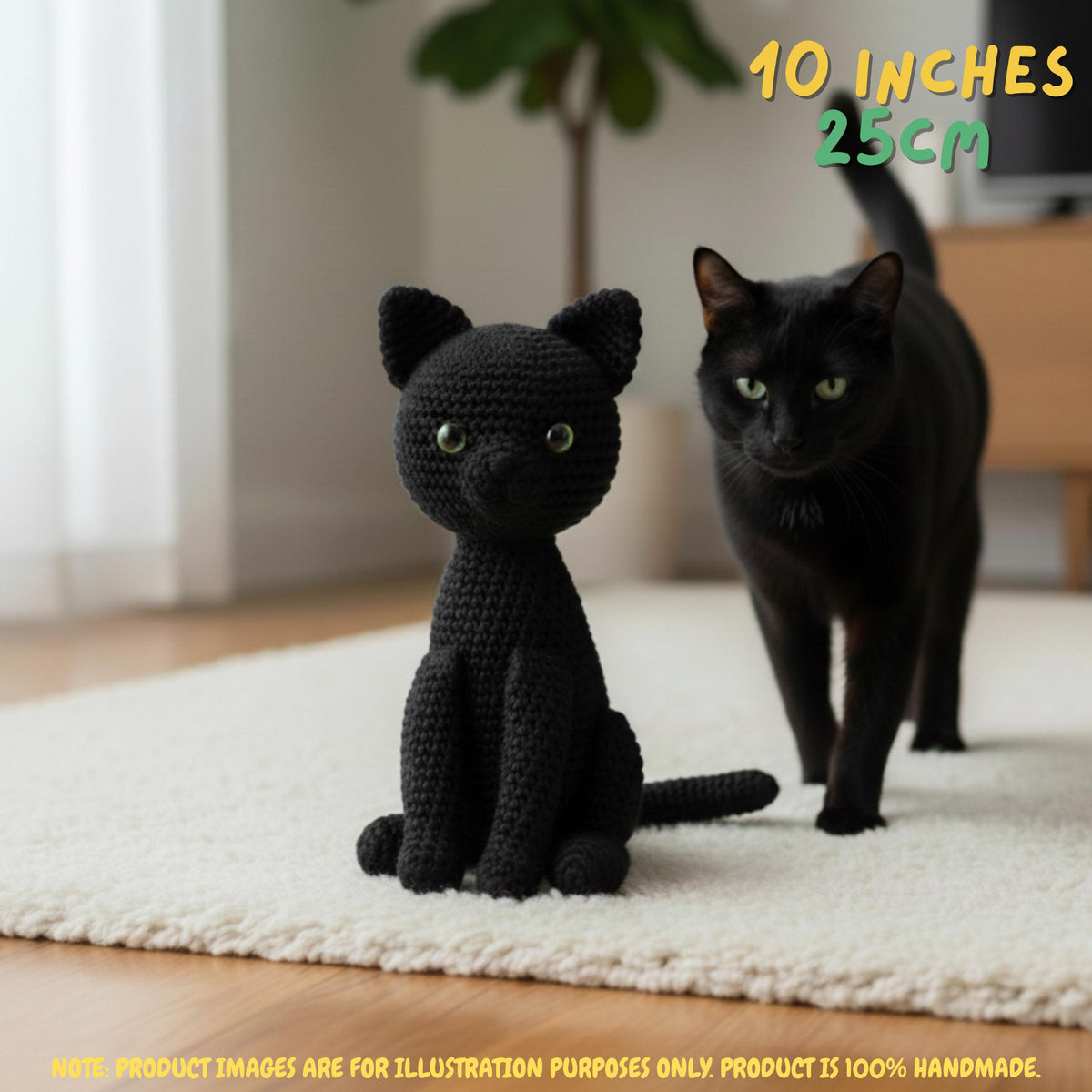A black crocheted cat plush toy sits on a white rug indoors, with a real black cat standing behind it. Yellow text in the top right reads '10 INCHES 25CM', and a note at the bottom says product images are for illustration purposes only because the product is 100% handmade.