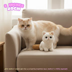 A cream-colored real cat stands on a beige sofa next to a small crocheted white cat toy. The scene is indoors with soft window light, and a pink text bubble in the top left says '8 INCHES 20CM'.