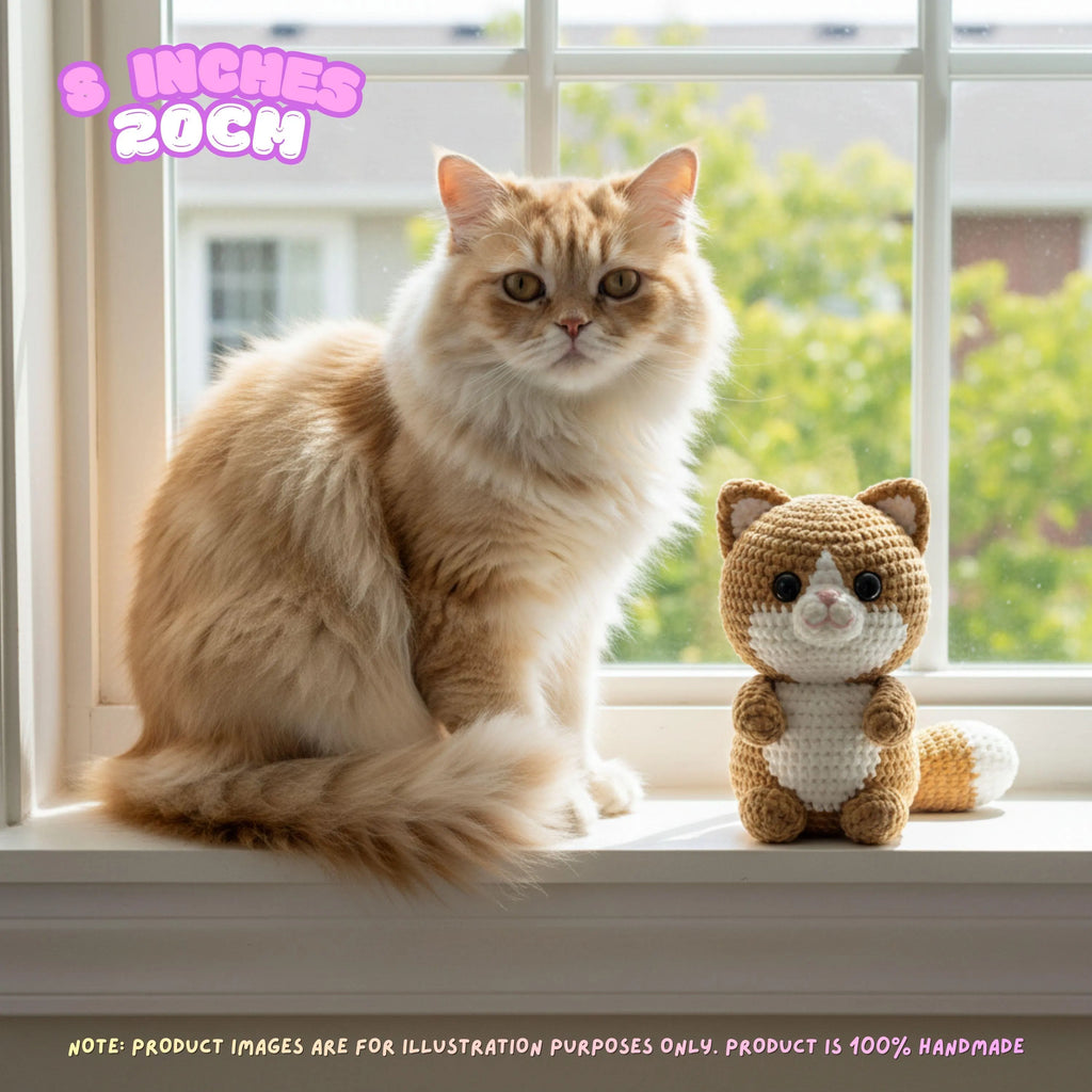 A fluffy orange cat sits on a windowsill next to a crocheted cat toy. Text in the top left says '5 INCHES 20CM', and a note at the bottom says product images are for illustration purposes only because the product is 100% handmade.