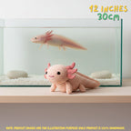 A crocheted axolotl toy in pale pink and peach sits on a wooden shelf in front of a glass aquarium with white gravel and a real axolotl swimming inside. Yellow text in the top right reads '12 INCHES 30CM', and a note at the bottom says the product images are for illustration purposes only because the product is 100% handmade.