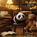 Hand gently touching top of a handmade giant panda bear crochet amigurumi plush doll sitting on a small chair next to a brown teddy bear and stacked vintage books in a cozy warm lighting room, with text reading 10 INCHES 25cm.