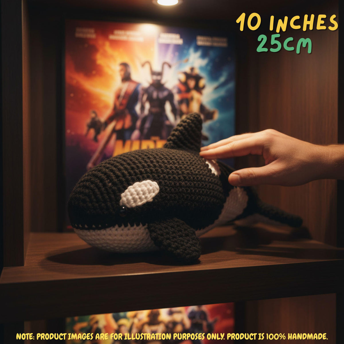 A crocheted orca plush toy resting on a wooden shelf, with a human hand touching its back. A Thor: Love and Thunder movie poster is displayed behind it, with text overlays indicating the size is 10 inches (25 cm) and a note that the product images are for illustration purposes only.