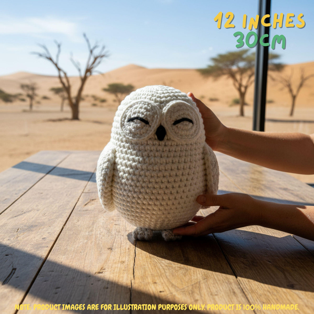 Handmade Snowy Owl crochet amigurumi plush doll held gently by hands on a wooden outdoor surface, with text indicating 12 inches 30 cm size.