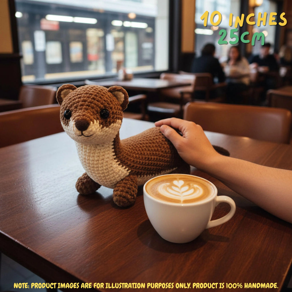 Handmade Stoat crochet amigurumi plush doll in brown and cream with a dark-tipped tail held gently by a hand, with text indicating 8 inches 20 cm size in a room setting.