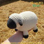 A crocheted sheep toy being held in a person's hand, photographed outdoors on a bed of straw. The text overlay reads '10 INCHES 25cm' and there is a small note at the bottom about product images being for illustration purposes.