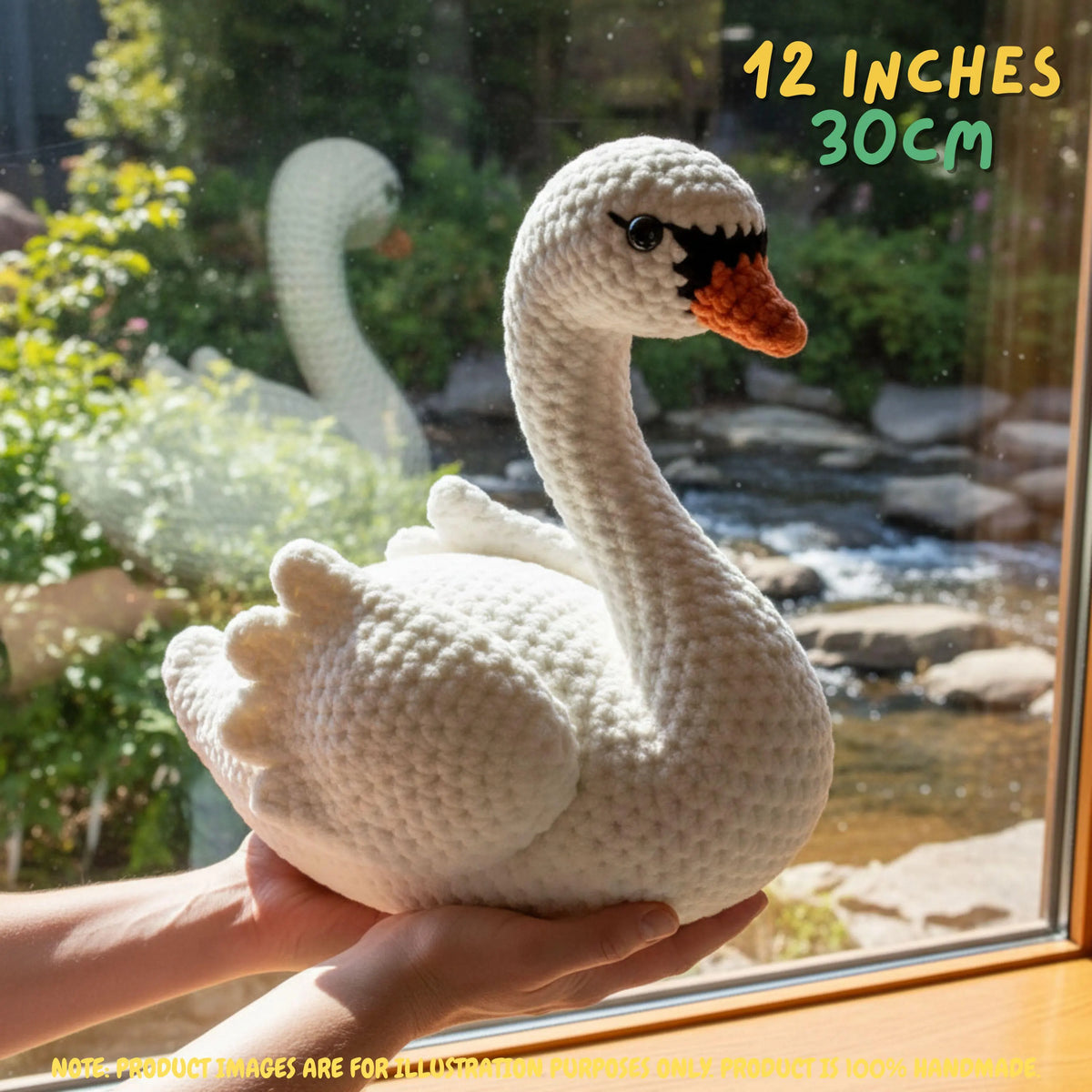 Handmade Mute Swan crochet amigurumi plush doll in white with an orange beak held gently by hands in front of a window overlooking a garden pond, with text indicating 12 inches 30 cm size.