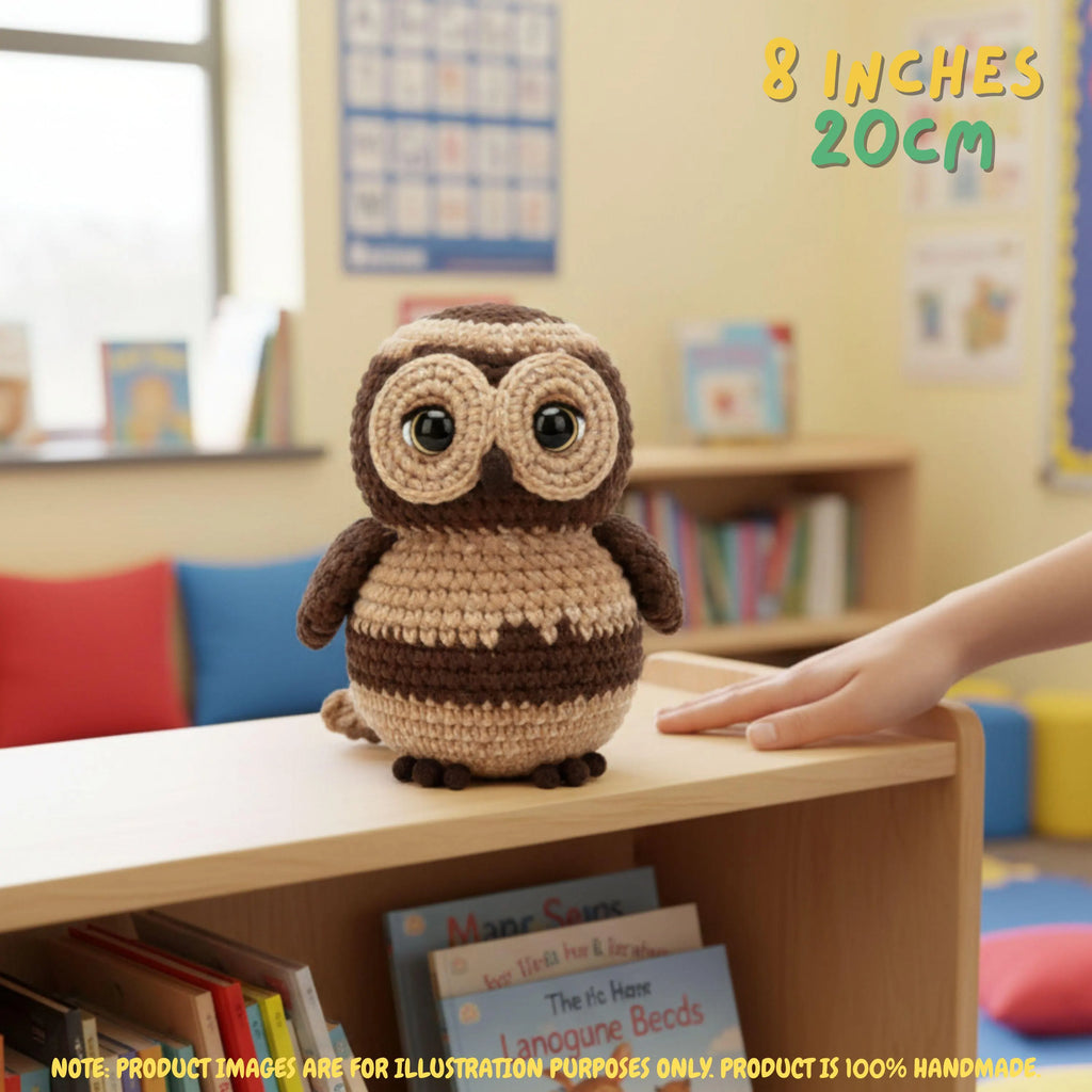 A crocheted owl toy sits on a wooden shelf in a children's room. A human hand reaches toward the toy, and text in the top right reads '8 INCHES 20CM'.