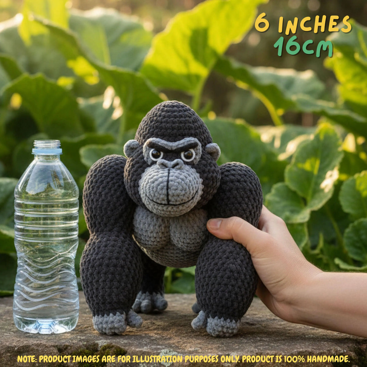 A crocheted gorilla toy is shown outdoors on a wooden surface with a hand holding it and a clear plastic bottle beside it for scale. Green leaves fill the background, and text in the top right reads '6 INCHES 16CM'.