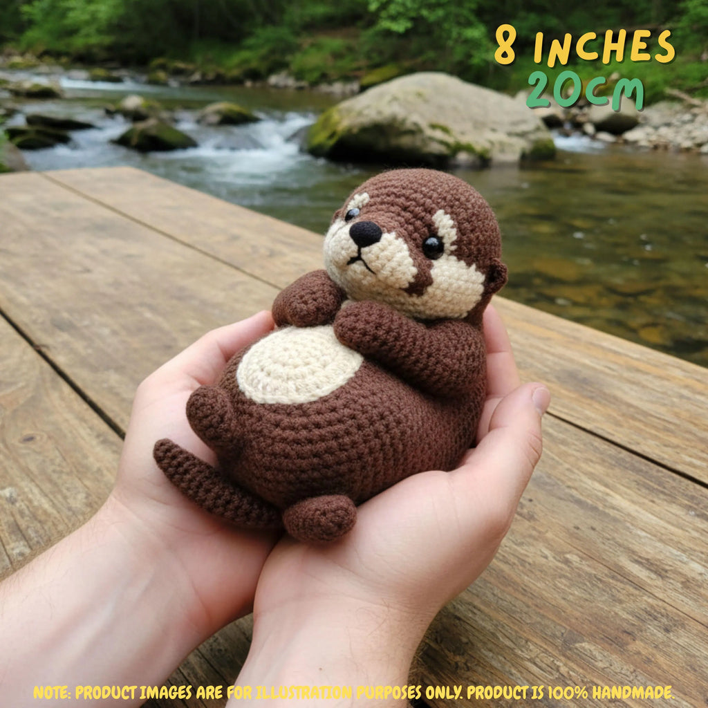 A crocheted otter plush toy being held in two hands, with a wooden deck and flowing river in the background. Yellow text in the top right reads '8 INCHES 20CM', and a note at the bottom says product images are for illustration purposes only.