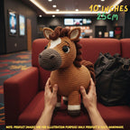 A crocheted plush horse toy being held by two hands on a red armchair in a real indoor environment, with overlaid text reading 10 INCHES 25CM and a note that product images are for illustration purposes only.