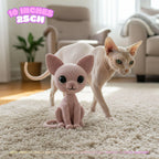 A crocheted cat toy in front of a real cat on a beige rug in a living room. Pink text in the top left reads '10 INCHES 25CM'.
