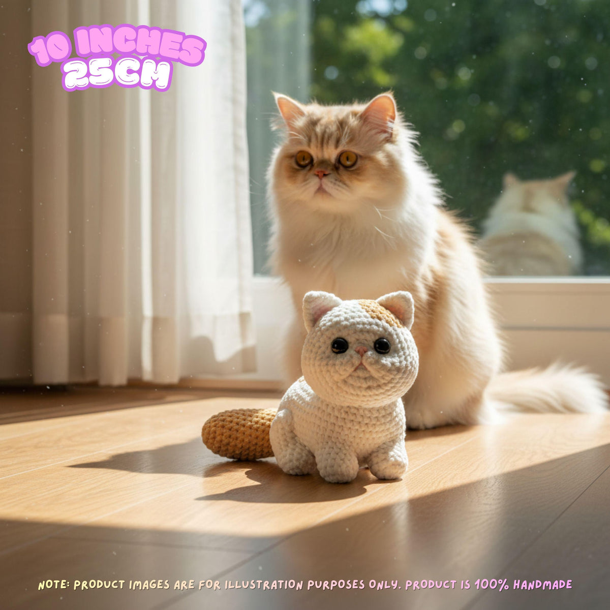 A small crocheted cat toy sits on a wooden floor in front of a fluffy cream-colored cat in a sunlit room. The image includes text overlays indicating the product size is 10 inches (25 cm) and a note that product images are for illustration purposes only.