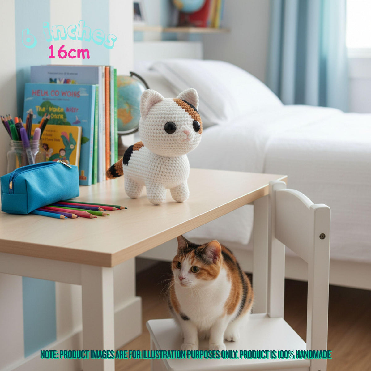A crocheted small cat toy sits on a children's desk in a bedroom setting, with a real calico cat underneath the desk. Text overlays indicate the toy is 3 inches / 16 cm.