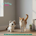A crocheted cat toy sits on a wooden floor next to a real orange-and-white cat in a sunlit room corner, with text noting the toy is 12 inches (30 cm) and a disclaimer that the product image is for illustration purposes only.