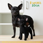 A small black crocheted dog toy stands in front of a real black dog in a bright indoor room. Yellow text in the top right reads '8 INCHES 20CM', and a yellow disclaimer runs along the bottom edge.