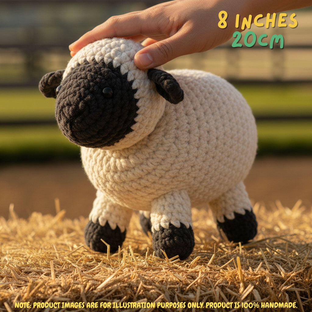 A crocheted sheep toy being held by a person's hand, standing on straw with a blurred outdoor background. Text in the top right says '8 INCHES 20CM', and a note at the bottom says the product is 100% handmade.
