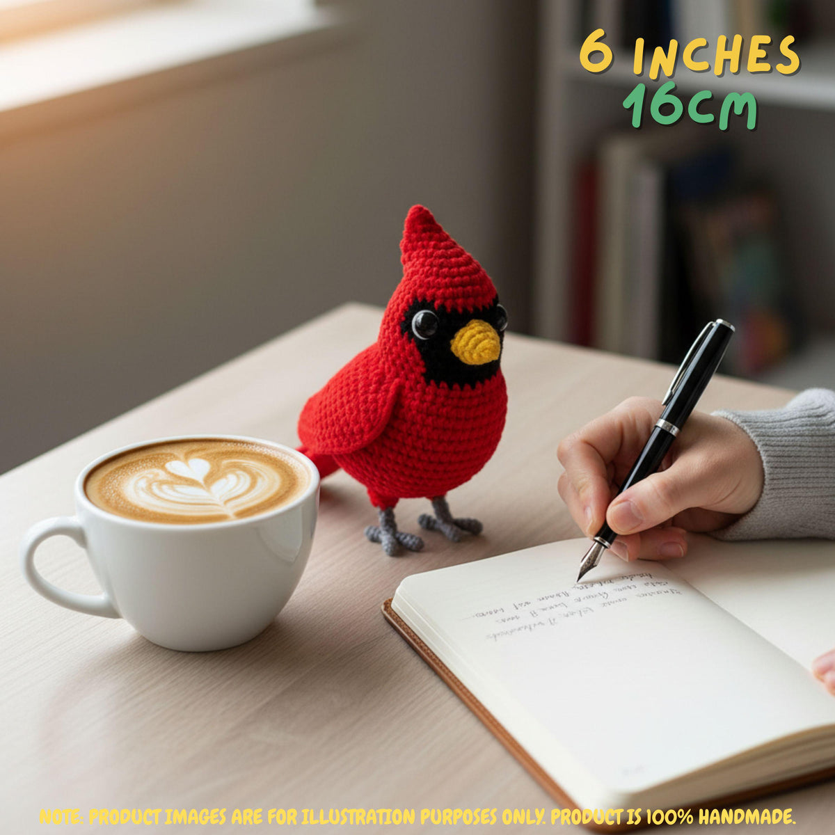 A red crocheted bird ornament stands on a wooden table beside a cup of latte art, an open notebook, and a hand holding a pen. Yellow text in the top right reads '6 INCHES 16CM', and a note at the bottom says product images are for illustration purposes only.