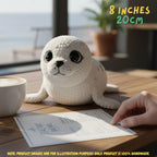 A small crocheted seal toy sits on a wooden table in a cafe-like setting, with a cup of coffee, a printed card, and a human hand visible. Text in the top right says 8 inches / 20 cm, and a note at the bottom says the product image is for illustration purposes only while the product is 100% handmade.