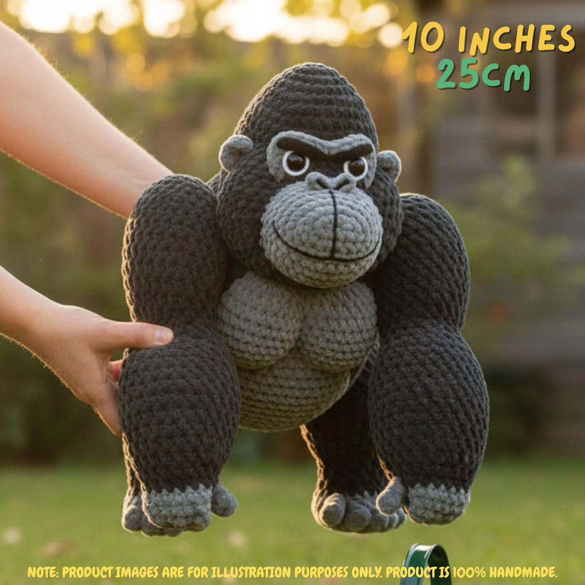 A crocheted gorilla toy being held by two hands outdoors, with text overlays indicating its size as 10 inches (25 cm) and a note that the product image is for illustration purposes only.