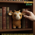 A crocheted small goat toy is displayed on a wooden bookshelf between vintage books, with a human hand touching its ear. Text in the top right says 8 inches / 20 cm, and a note at the bottom says product images are for illustration purposes only.