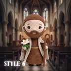 A crocheted amigurumi figure of a bearded man in brown robes and a cream coat, holding a white flower and a staff, standing in front of a blurred cathedral interior. The text 'STYLE 6' appears in the lower left corner.