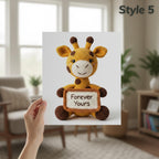 A hand holds a printed card or poster featuring a crocheted giraffe holding a sign that says 'Forever Yours,' with the text 'Style 5' in the top right. The background shows a softly blurred living room interior with a chair, windows, and plants.