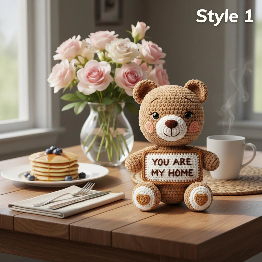 A crocheted teddy bear sits on a wooden table holding a sign that reads 'YOU ARE MY HOME.' The scene is styled like a breakfast table with pancakes, blueberries, a vase of pink roses, a white mug with steam, and the text 'Style 1' in the top right corner.