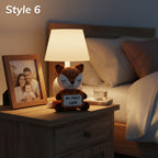 A crocheted fox night light holding a sign that says 'MY FIRST LOVE' sits on a wooden bedside table next to a lit lamp and a framed family photo, with a bed in the background. The text 'Style 6' appears in the top left corner.