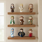 Nine small fabric doll figures arranged on three wooden floating shelves against a warm beige wall, with a soft window light on the left side.