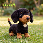 A crocheted dachshund-style dog toy sits on green grass outdoors, with a blurred garden background and the text 'STYLE 1' in the upper left corner.