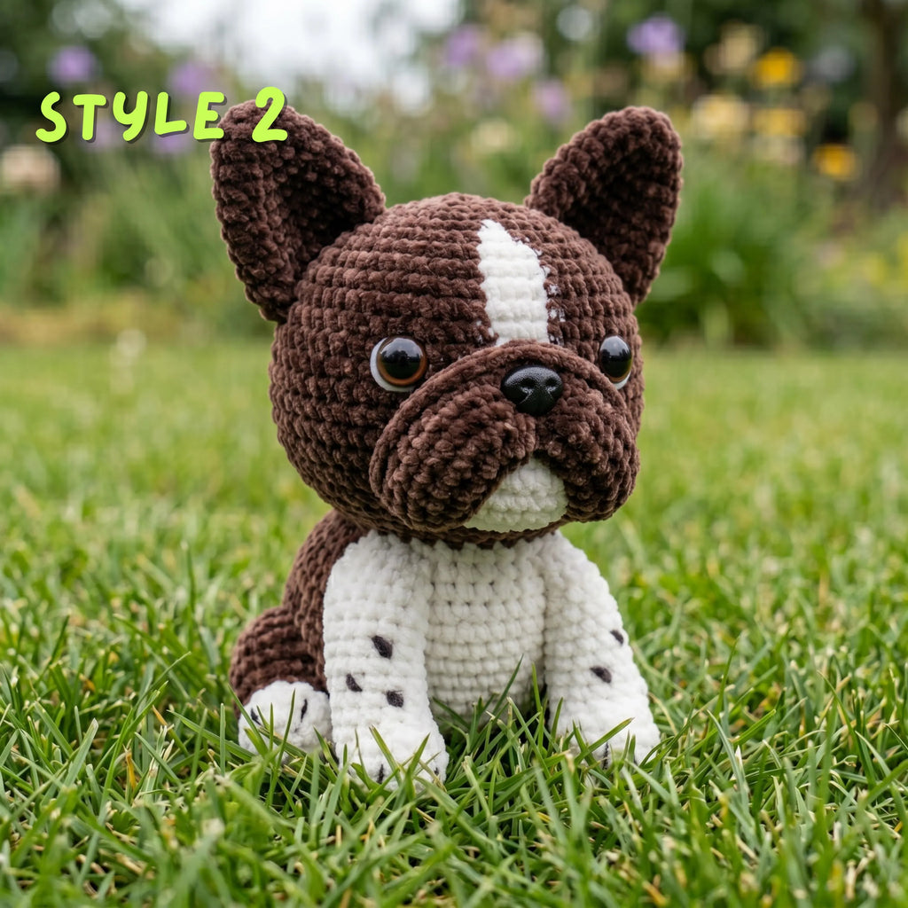 Handmade brown and white crochet French Bulldog amigurumi plushie with "STYLE 2" text overlay sitting on green grass.