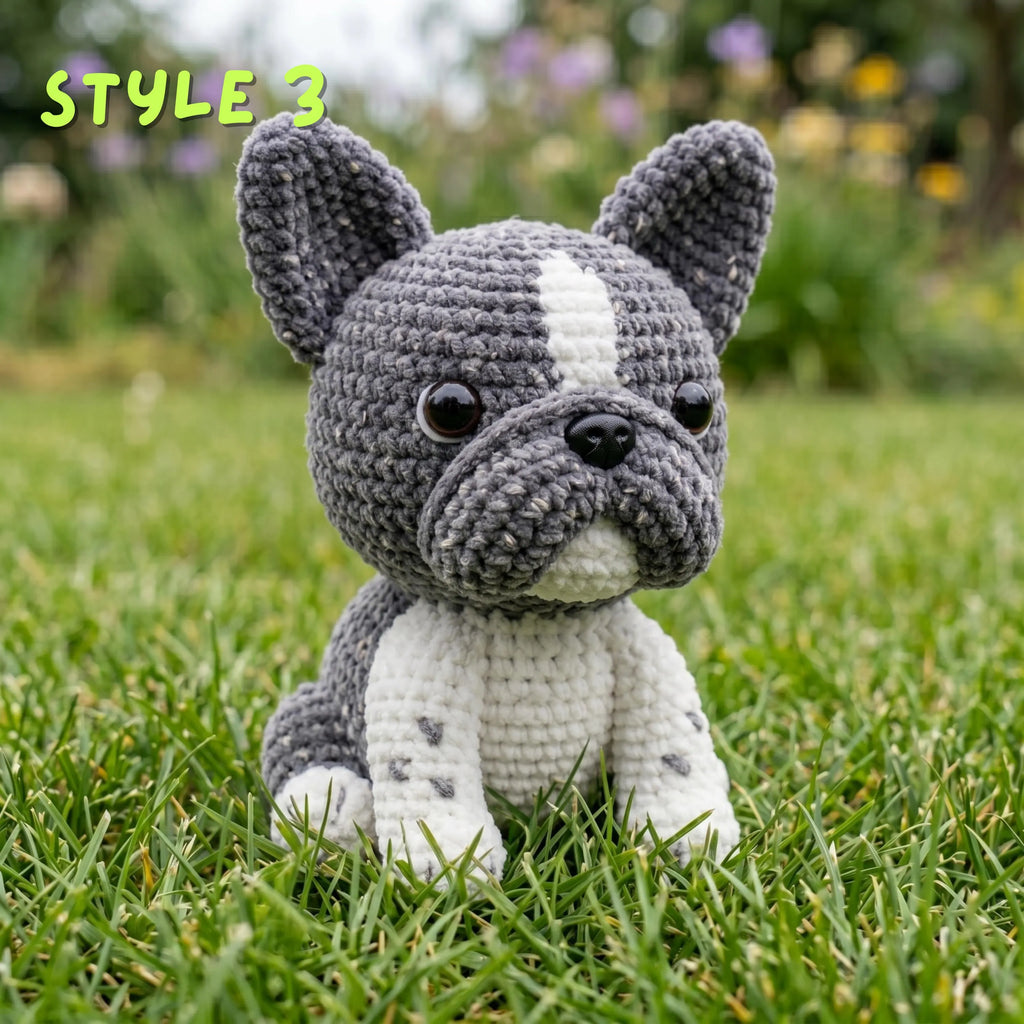 Custom crochet French Bulldog amigurumi doll in grey and white coat on outdoor lawn display.